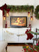 Mercury glass pinecone ornaments glowing beneath a Christmas mantel garland