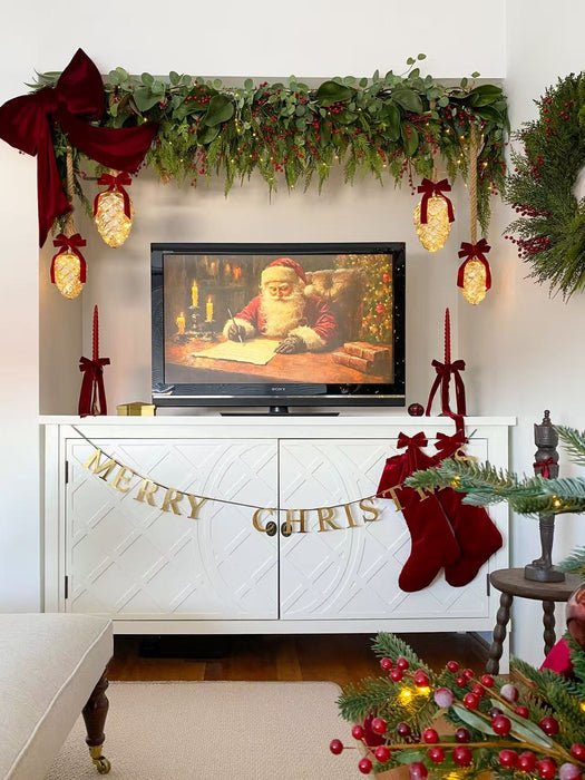 Mercury glass pinecone ornaments glowing beneath a Christmas mantel garland