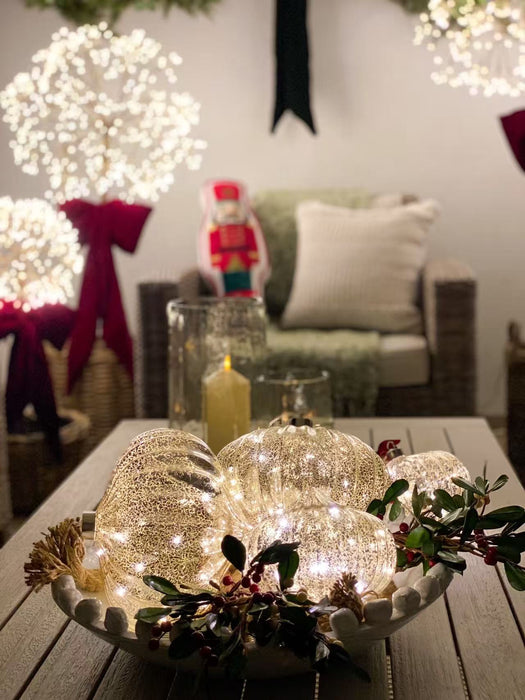 Mercury glass onion ornaments glowing in a festive table centrepiece