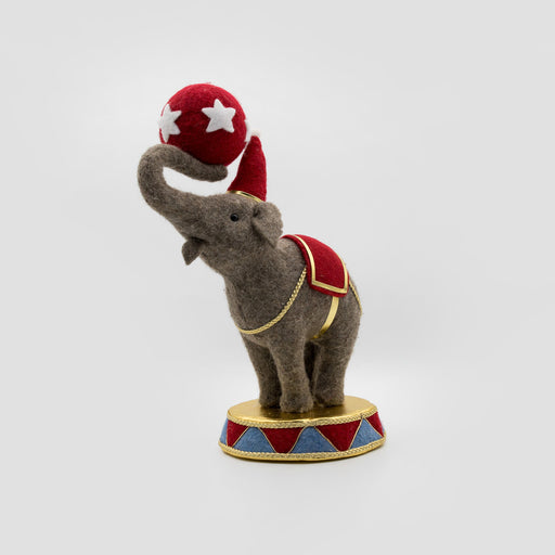 Felt circus elephant balancing a red star ball – left angle