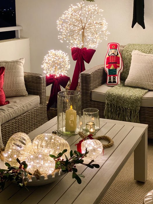 Dandelion lights glowing above an elegant Christmas table display