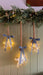 Mercury glass LED stars in different sizes styled beneath Christmas greenery