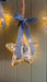 Illuminated mercury glass star hanging with a blue velvet bow