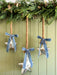 Mercury glass hanging stars styled with rope and blue velvet bows