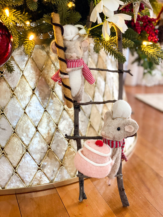 Felt cookie roll mouse and cake mouse climbing a rustic twig ladder