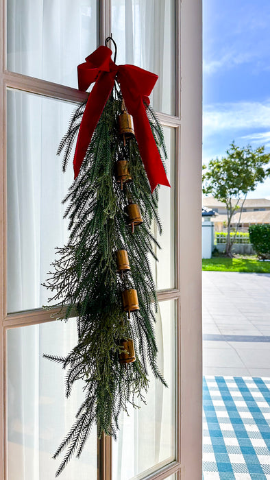 100cm Christmas swag with golden bells styled on a glass door with a red velvet bow