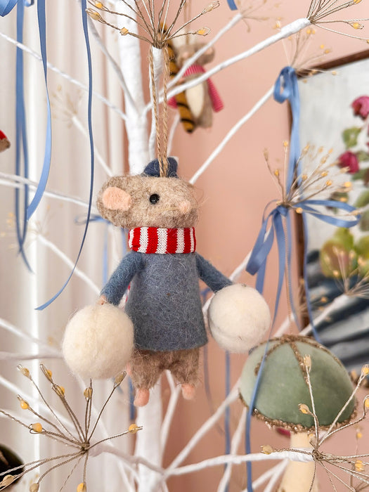 Felt mouse holding snow balls on an illuminated white Christmas tree