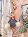 Felt mouse holding snow balls on an illuminated white Christmas tree