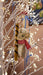 Felt mouse holding a cookie roll on an illuminated white Christmas tree